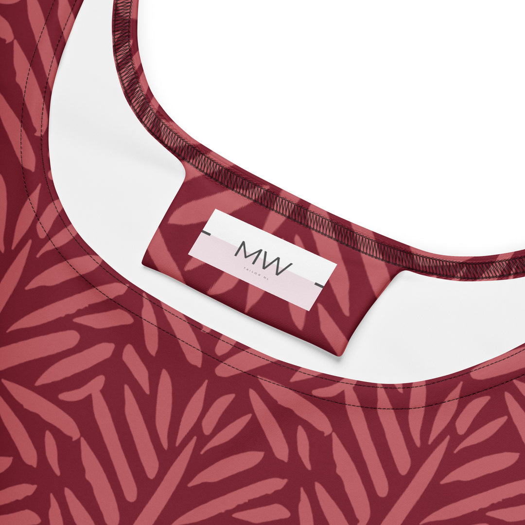 Close-up van het Measterwerk kledinglabel en het all-over geprinte bloemenpatroon rood van de skaterjurk.